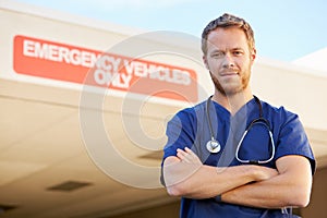 Portrait Of Male Doctor Standing Outside Hospital