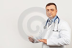 Portrait of a male doctor using a digital tablet