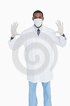 Portrait of male doctor wearing mask and gloves
