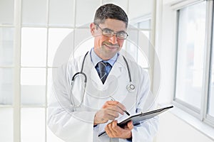 Portrait of a male doctor writing reports