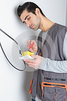 portrait male electrician wiring switch