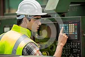 Portrait of male Engineer standing with confident against machine environment in factory