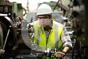 Portrait of male Engineer standing with confident against machine environment in factory