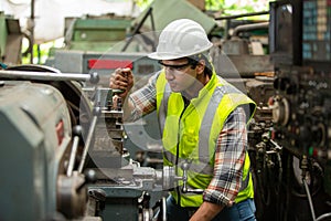 Portrait of male Engineer standing with confident against machine environment in factory