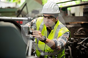 Portrait of male Engineer standing with confident against machine environment in factory