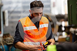 Portrait of male Engineer standing with confident against machine environment in factory