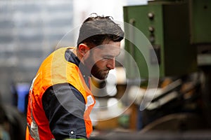 Portrait of male Engineer standing with confident against machine environment in factory