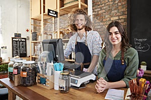 Portrait Of Male And Female Owners Of Sustainable Plastic Free Grocery Store Behind Sales Desk