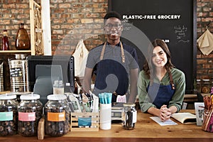 Portrait Of Male And Female Owners Of Sustainable Plastic Free Grocery Store Behind Sales Desk