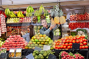 Shop assistants working in fruit and vegetable shop photo