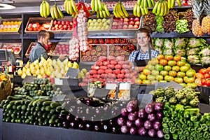 Shop assistants working in fruit and vegetable shop photo