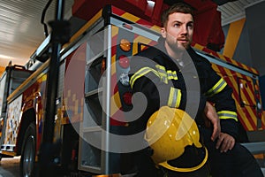 Portrait of male firefighter in uniform at fire station