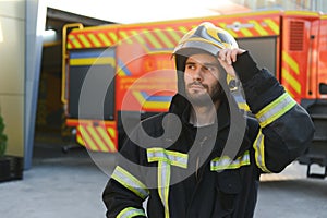 Portrait of male firefighter in uniform at fire station