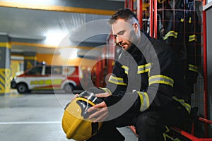 Portrait of male firefighter in uniform at fire station