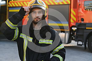 Portrait of male firefighter in uniform at fire station