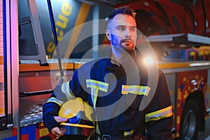 Portrait of male firefighter in uniform at fire station