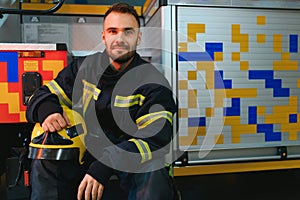 Portrait of male firefighter in uniform at fire station