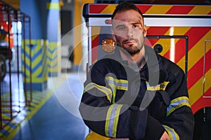 Portrait of male firefighter in uniform at fire station