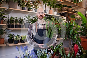 Portrait of male florist with arms crossed at his flower shop