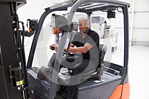 Portrait Of Male Fork Lift Truck Driver In Factory