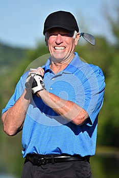 Portrait Of A Male Golfer With Golf Club Playing Golf