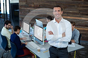 Portrait of male graphic designer standing with arms crossed