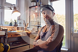 Portrait Of Male Jeweller Wearing Headband Magnifiers Working In Studio