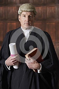 Portrait Of Male Lawyer In Court Holding Brief And Book