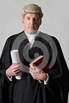 Portrait Of Male Lawyer Holding Brief And Book