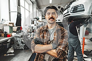 Portrait of a male mechanic in an auto repair shop close up