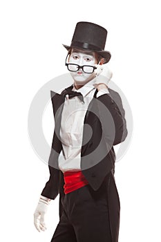 Portrait of male mime artist performing, isolated on white background. Mime lowered his glasses to look directly into