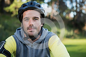 Portrait of male mountain biker riding bicycle in the forest