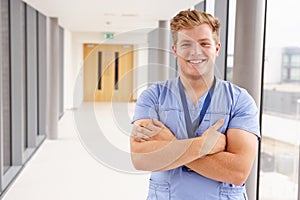 Portrait Of Male Nurse Standing In Hospital Corridor