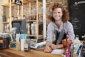 Portrait Of Male Owner Of Sustainable Plastic Free Grocery Store Behind Sales Desk