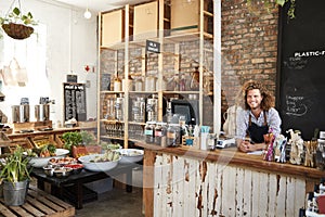 Portrait Of Male Owner Of Sustainable Plastic Free Grocery Store Behind Sales Desk