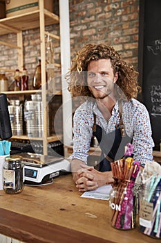 Portrait Of Male Owner Of Sustainable Plastic Free Grocery Store Behind Sales Desk