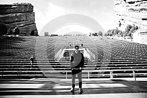 Portrait of Male Person Standing Front and Center on a Stage Dreaming and Imagining the Future while Facing Stadium