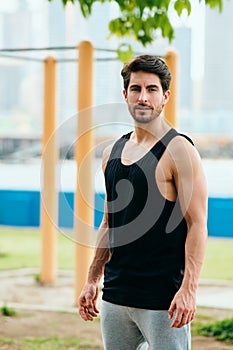 Portrait of Male Personal Trainer Working Out In City Park