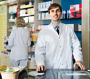 Portrait of male pharmacists working in modern farmacy photo