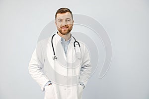 Portrait of a male physician looking at camera isolated on white background