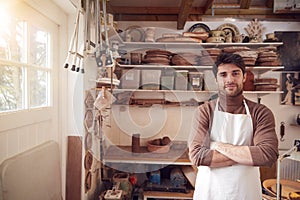 Portrait Of Male Potter Wearing Apron In Ceramics Studio