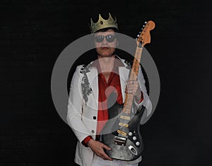 portrait of male rock guitarist on a black background