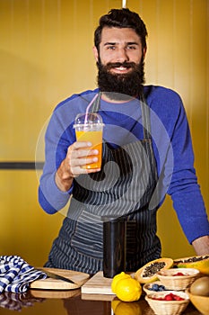 Portrait of male staff holding juice glass