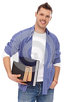 Portrait of male student with books smiling