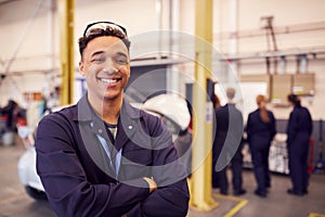 Portrait Of Male Student With Safety Glasses Studying For Auto Mechanic Apprenticeship At College photo