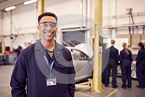 Portrait Of Male Student With Safety Glasses Studying For Auto Mechanic Apprenticeship At College