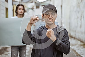 Portrait male students holding blank paper who are burning with enthusiasm