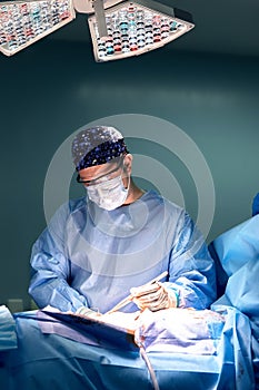 Portrait of a male surgeon in the operating room on the background of modern surgery and lighting devices, a modern