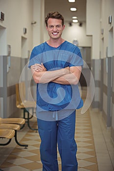 Portrait of male surgeon standing in corridor