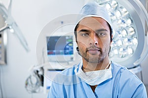Portrait of male surgeon standing in operation theater